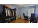 Bedroom with hardwood floors, clothing rack, gaming chair, and window providing natural light at 3064 Baymount Way, Lawrenceville, GA 30043