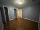 Bedroom with laminate floors, neutral walls, and access to other rooms at 3064 Baymount Way, Lawrenceville, GA 30043