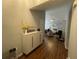 Entryway featuring wood floors, storage console, and a glimpse into the living space at 3064 Baymount Way, Lawrenceville, GA 30043