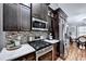Modern kitchen with stainless steel appliances and dark cabinets at 3064 Baymount Way, Lawrenceville, GA 30043