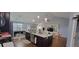 Open concept living space featuring a large island and connecting dining and living areas at 3064 Baymount Way, Lawrenceville, GA 30043