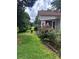 Charming home featuring a well-manicured front yard with lush greenery and beautiful flowers at 702 Moon Rd, Lawrenceville, GA 30046