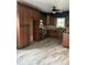 Kitchen featuring dark wood cabinetry, stainless steel appliances, granite countertops, and modern flooring at 702 Moon Rd, Lawrenceville, GA 30046