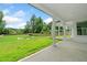 Covered porch view of the expansive backyard with a geometric pool and professionally manicured lawn and landscaping at 103 Maddox Rd, Buford, GA 30518