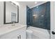 Modern bathroom featuring a bathtub with dark blue subway tiles and quartz countertops at 103 Maddox Rd, Buford, GA 30518