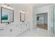 Bright primary bathroom featuring dual sinks, marble countertops and floors, and a glass-enclosed shower at 103 Maddox Rd, Buford, GA 30518
