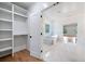 Bathroom featuring marble floors, walk-in closet, glass shower, soaking tub and a view of the bedroom at 103 Maddox Rd, Buford, GA 30518