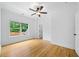 Well-lit bedroom with hardwood floors and a large window at 103 Maddox Rd, Buford, GA 30518