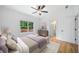 Bright bedroom featuring neutral decor, wood floors, a ceiling fan, and large windows at 103 Maddox Rd, Buford, GA 30518