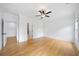 Spacious bedroom with hardwood floors, ceiling fan, and neutral paint at 103 Maddox Rd, Buford, GA 30518