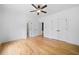 Spacious bedroom featuring hardwood floors, a ceiling fan, and a double door closet at 103 Maddox Rd, Buford, GA 30518