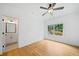 Bright bedroom with hardwood floors, a ceiling fan, and large windows at 103 Maddox Rd, Buford, GA 30518