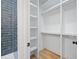Walk-in closet with custom shelving and rods for organized storage at 103 Maddox Rd, Buford, GA 30518