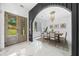 Dining room showcasing natural light, a modern chandelier, and access to the front door at 103 Maddox Rd, Buford, GA 30518