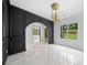 Elegant dining room boasts marble floors, modern lighting, and striking black wainscoting detail at 103 Maddox Rd, Buford, GA 30518