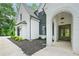 Charming front entrance with stone archway and custom wood double doors at 103 Maddox Rd, Buford, GA 30518