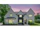 Beautifully landscaped two-story white brick home with a modern black and white facade at 103 Maddox Rd, Buford, GA 30518