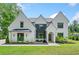 Stunning two-story white brick home with black-framed windows and manicured lawn at 103 Maddox Rd, Buford, GA 30518
