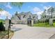 Gated entrance to the property with a spacious driveway leading to the house and garage at 103 Maddox Rd, Buford, GA 30518
