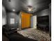Stunning home theater with tiered seating, dark walls, accent lighting, and a flat screen television at 103 Maddox Rd, Buford, GA 30518