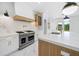 Beautiful kitchen with custom white and wood cabinets, marble backsplash, a stainless steel range, and stainless steel appliances at 103 Maddox Rd, Buford, GA 30518