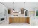 Spacious kitchen featuring a large island, custom cabinetry, and pendant lighting at 103 Maddox Rd, Buford, GA 30518