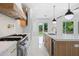 Bright kitchen with white marble floors and countertops, and an expansive island with gold fixtures at 103 Maddox Rd, Buford, GA 30518