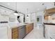 Modern kitchen features stainless steel appliances, center island, wine fridge and marble flooring at 103 Maddox Rd, Buford, GA 30518