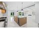 Modern kitchen featuring a large island with seating, stainless appliances, and lots of natural light. Backyard views at 103 Maddox Rd, Buford, GA 30518