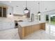 Gourmet kitchen with a large island, white marble countertops, and stainless steel appliances at 103 Maddox Rd, Buford, GA 30518