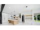 Open-concept kitchen showcasing an island, stainless appliances, and custom cabinetry at 103 Maddox Rd, Buford, GA 30518
