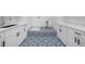 Bright laundry room featuring custom tile floor and bright white cabinets at 103 Maddox Rd, Buford, GA 30518