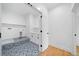 Bright laundry room featuring custom tile floor and bright white cabinets at 103 Maddox Rd, Buford, GA 30518