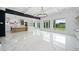 Open floorplan with marble floors flowing from the kitchen to the living room with backyard views at 103 Maddox Rd, Buford, GA 30518