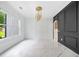 Bright living area with large window, stylish lighting, and white marble-like floors at 103 Maddox Rd, Buford, GA 30518