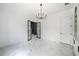 Bright and spacious living area with modern lighting, black framed opening, and marble-like floors at 103 Maddox Rd, Buford, GA 30518