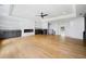 Bright living room with fireplace, ceiling fan, hardwood floors and custom cabinets at 103 Maddox Rd, Buford, GA 30518