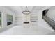 Bright living room with marble flooring, tray ceiling, built-ins, and a modern fireplace at 103 Maddox Rd, Buford, GA 30518