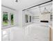 Bright living room with a fireplace, custom built-ins, coffered ceilings, modern lighting and access to the backyard at 103 Maddox Rd, Buford, GA 30518
