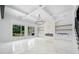 Open-concept living room with a fireplace, built-in shelving and cabinetry, coffered ceilings, and large windows at 103 Maddox Rd, Buford, GA 30518