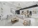 Bright, open-concept living room featuring a coffered ceiling, modern chandelier and views into the kitchen and dining area at 103 Maddox Rd, Buford, GA 30518
