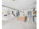 Expansive living space with marble floors connecting the kitchen, living room, and staircase at 103 Maddox Rd, Buford, GA 30518