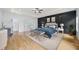 Beautiful primary bedroom with an accent wall, ensuite bathroom, natural lighting, and hardwood floors at 103 Maddox Rd, Buford, GA 30518