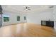 Bright main bedroom with hardwood floors, tray ceiling, and large windows offering scenic views at 103 Maddox Rd, Buford, GA 30518