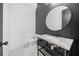 Modern powder room with stylish fixtures, a marble countertop, and dark accent wall at 103 Maddox Rd, Buford, GA 30518