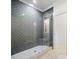 Modern bathroom shower with dark grey herringbone tile, glass enclosure, and a white shower base at 103 Maddox Rd, Buford, GA 30518