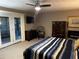 Bedroom with large windows, ensuite access to screened porch, modern ceiling fan, and TV mounted on the wall at 3474 Leaf Land Ct, Duluth, GA 30097