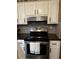 Stainless steel stove with butcher block countertops and white cabinets at 3474 Leaf Land Ct, Duluth, GA 30097