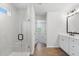 Bathroom featuring a glass shower, double sink vanity, and wood look flooring at 4778 Moonstone Trce, Kennesaw, GA 30144