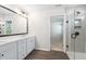 Bright bathroom with a glass-enclosed shower, dual sinks, and a large mirror over the vanity at 4778 Moonstone Trce, Kennesaw, GA 30144